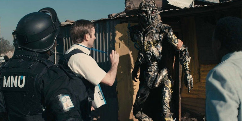 Police officials speak with a Prawn in District 9