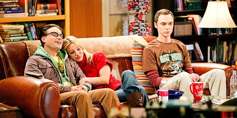 Johnny Galecki's Leonard, Kaley Cuoco's Penny, and Jim Parsons' Sheldon sitting on couch in The Big Bang Theory 