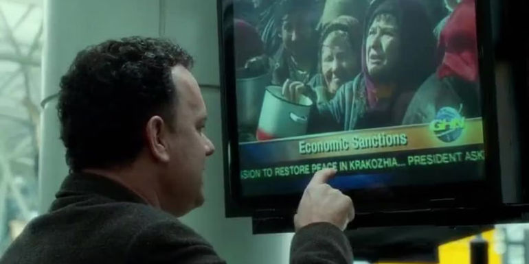 Navorski (Tom Hanks) pointing at a TV in The Terminal