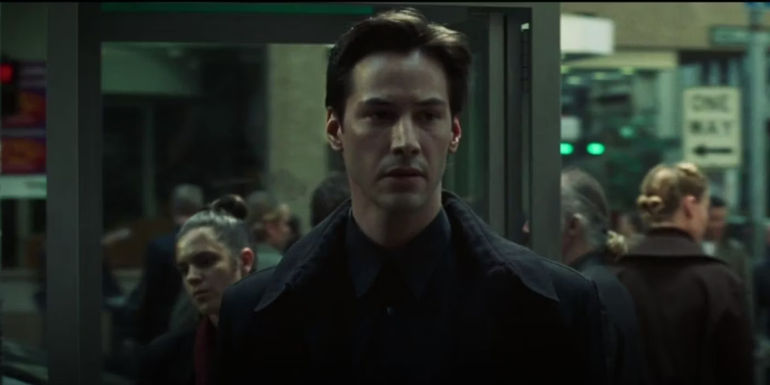 Neo leaves a telephone booth after promising to save everyone by freeing their minds