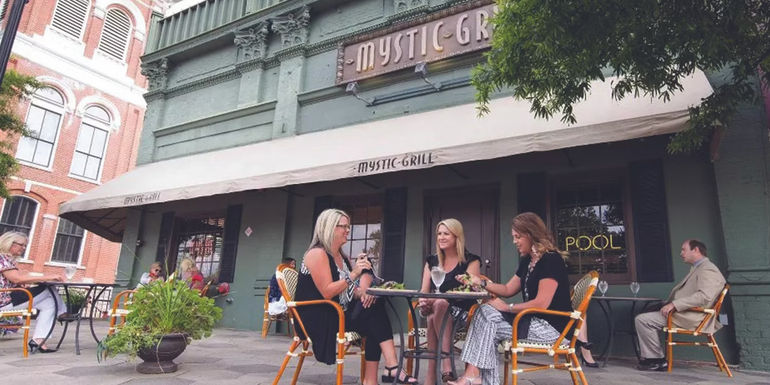 Women at a table outside the real Mystic Grill where the Vampire Diaries filmed in Georgia