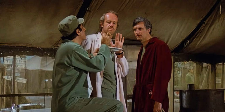 Jamie Farr's Klinger, Mike Farrell's BJ, and Alan Alda's Hawkeye in MASH season 8