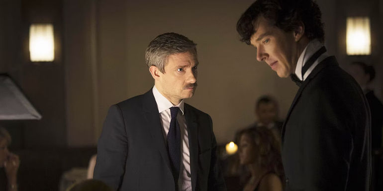 John Watson (Martin Freeman) looking serious next to a sad Sherlock (Benedict Cumberbatch) in Sherlock season 3 episode The Empty Hearse