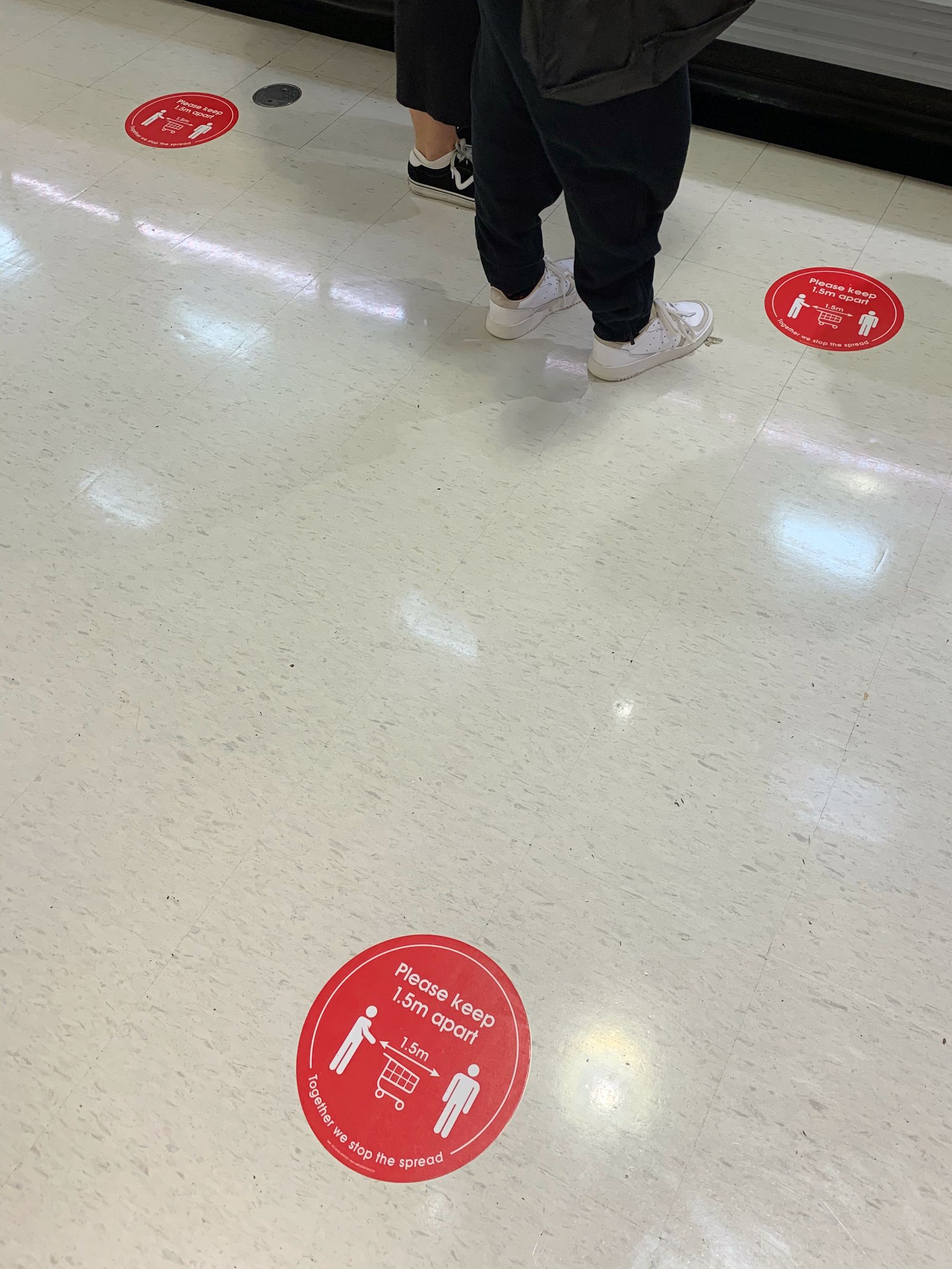 Coronavirus public safety floor signage inside a Coles supermarket