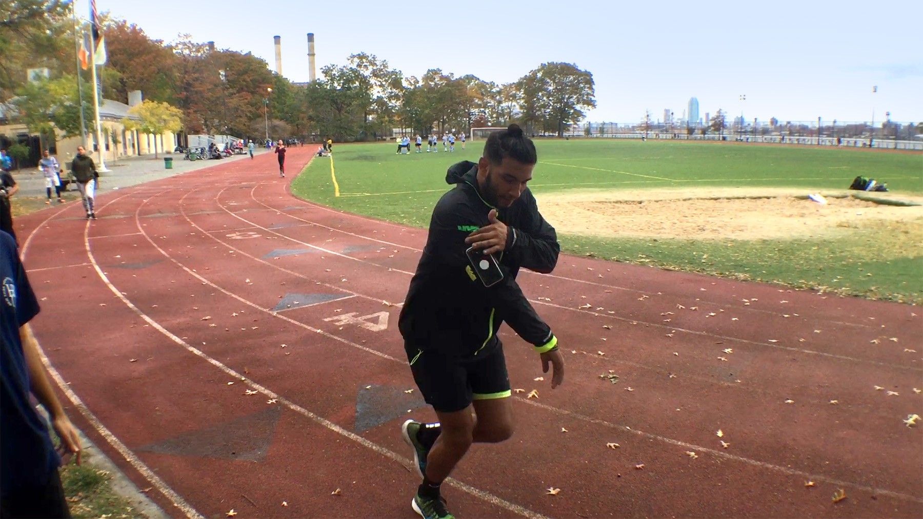 A trainer running on a track with the prototype attached to his arm