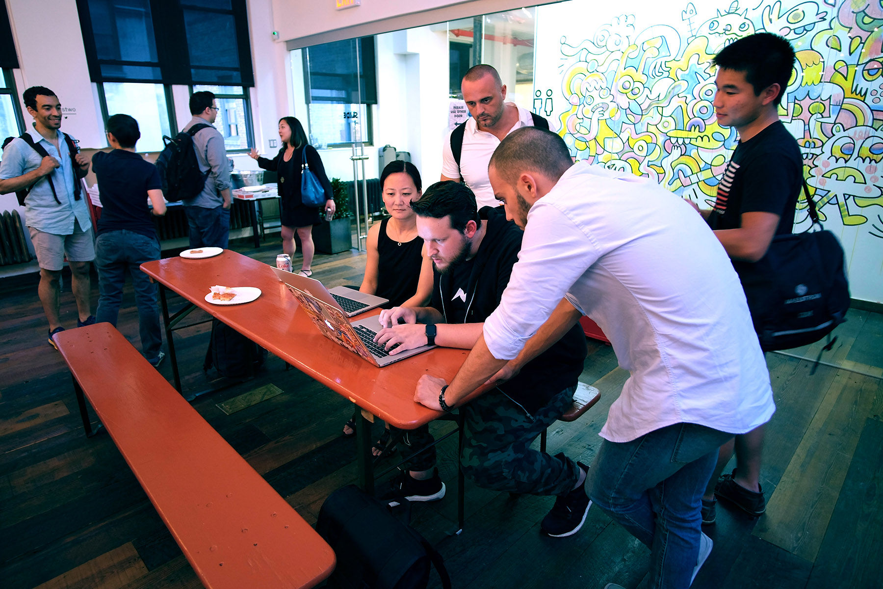 Several people looking at a computer