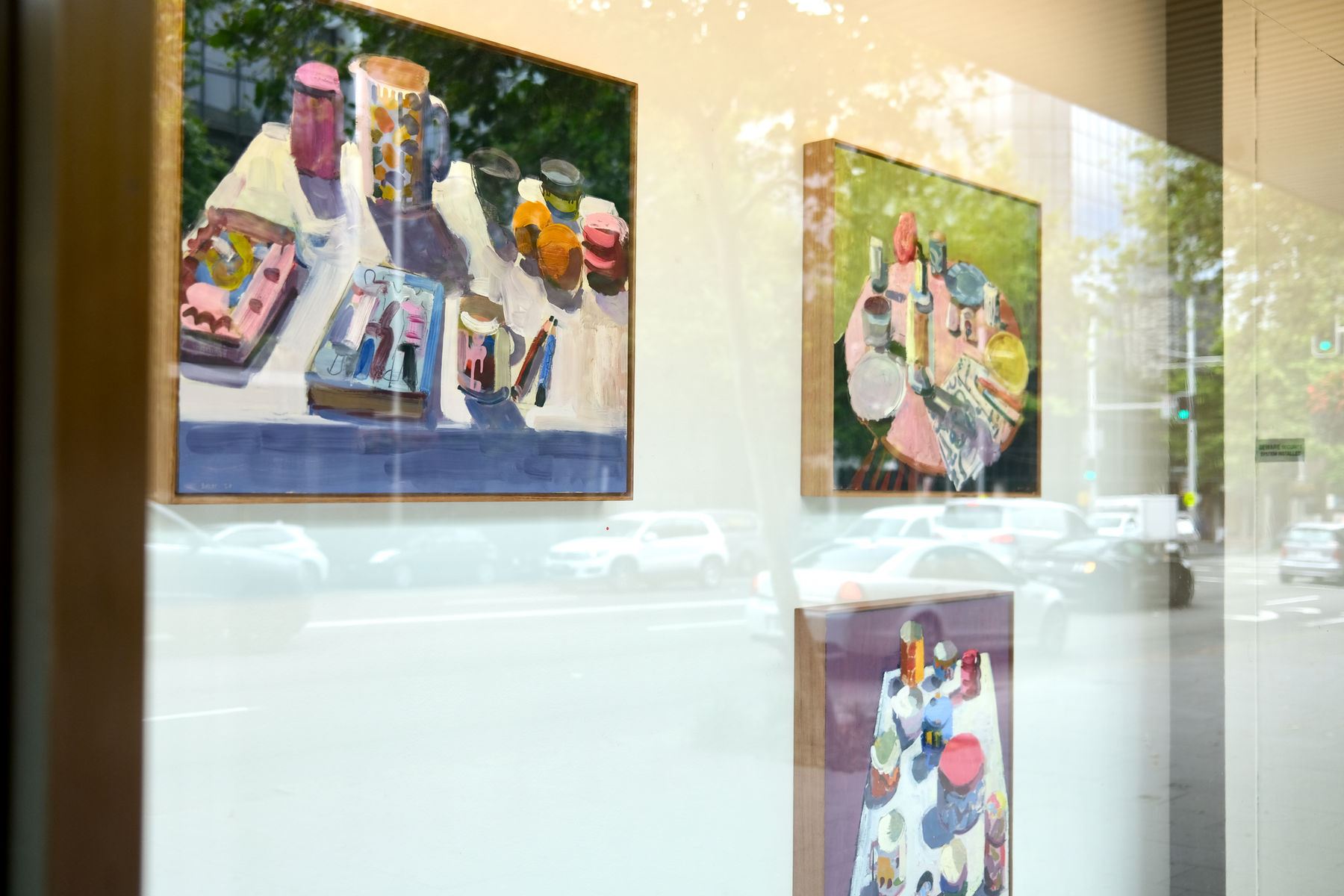 An empty art exhibition with paintings on the wall