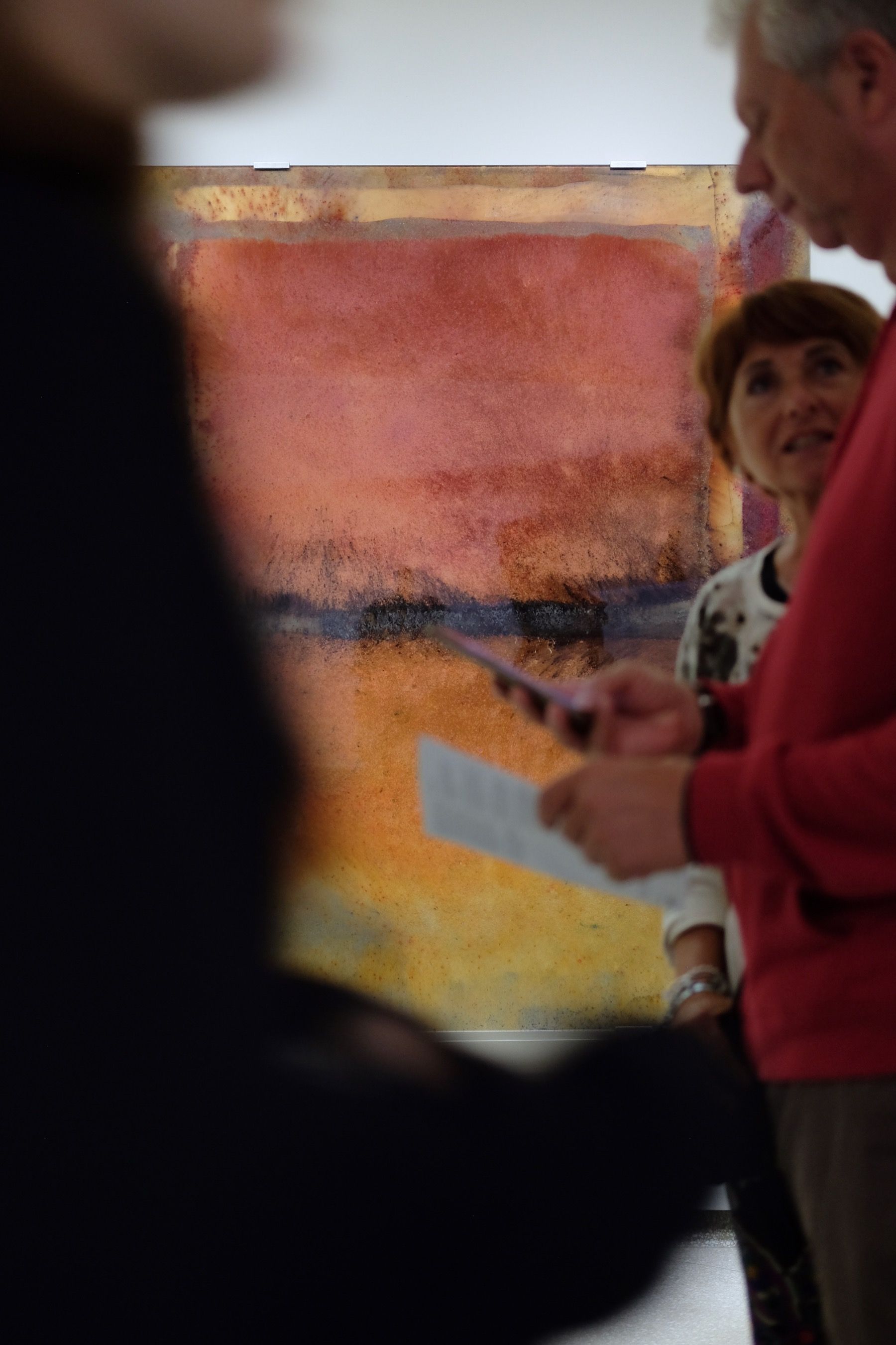 People walking past an artwork