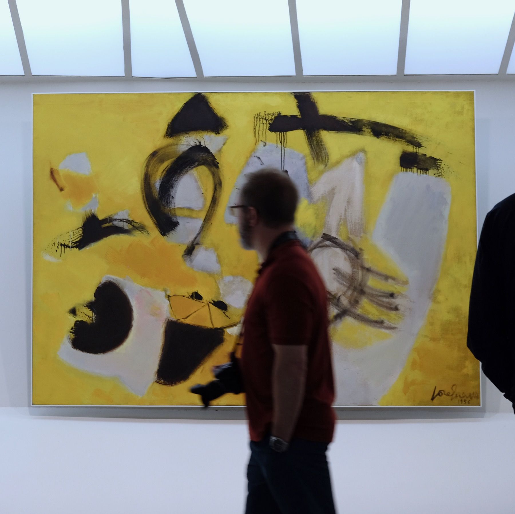People walking past an artwork