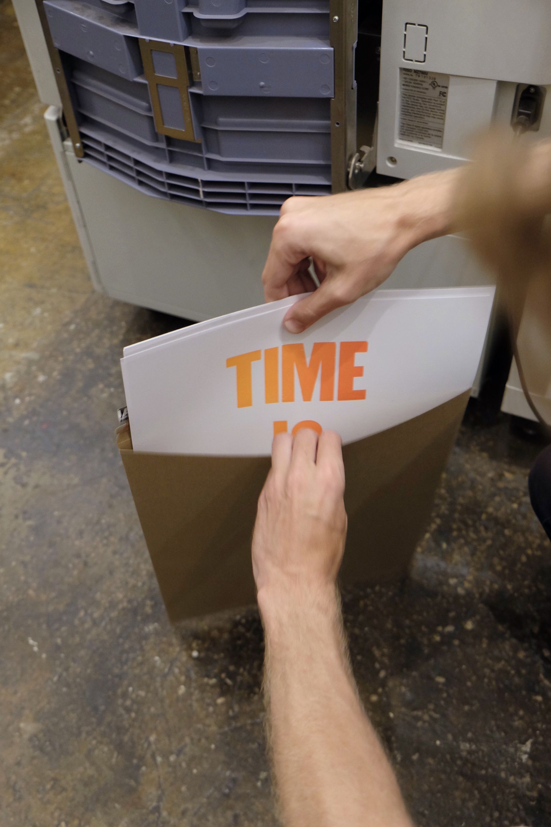 Jon packing an envelope with posters