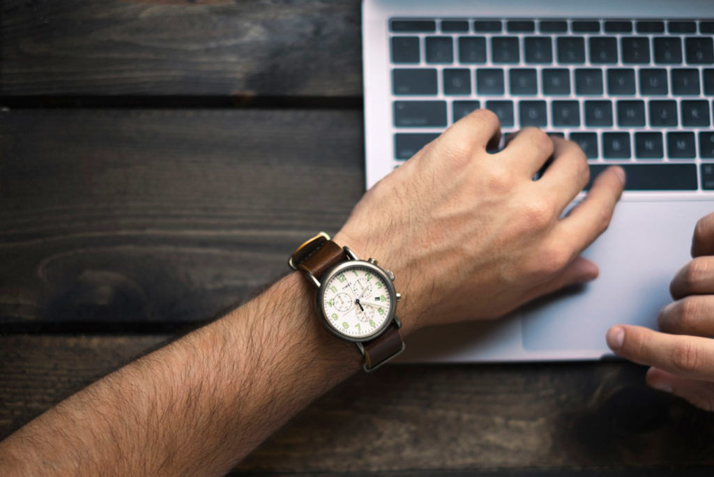 Arm with a watch, showing time