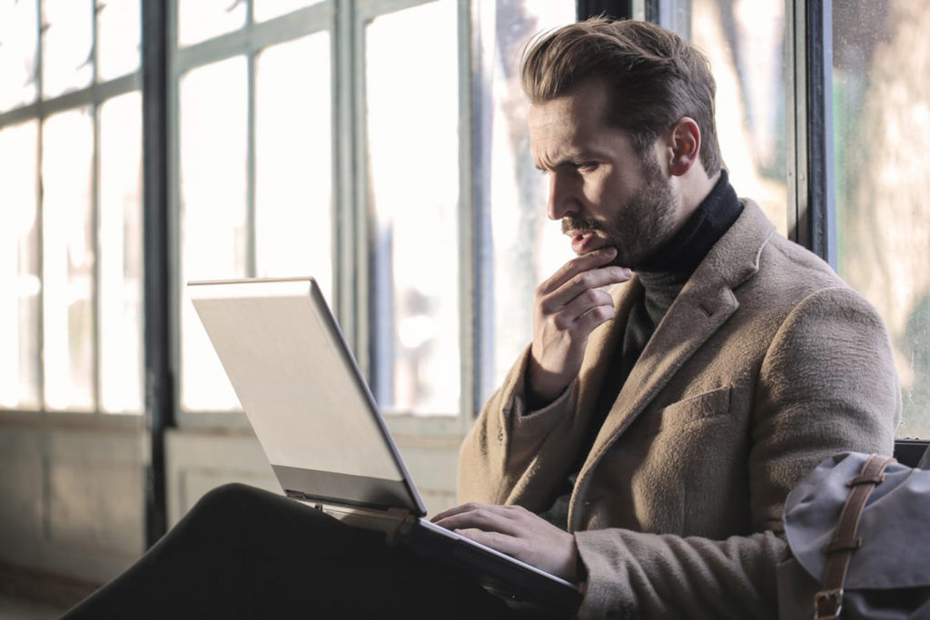 man looking confused on laptop