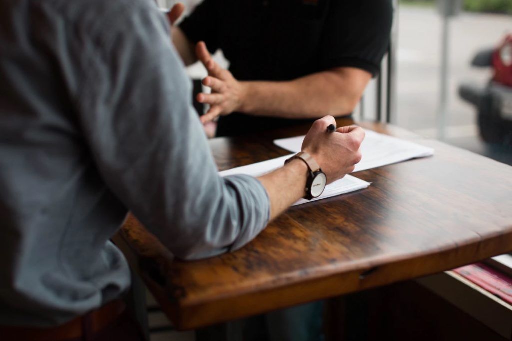 People talking over a desk