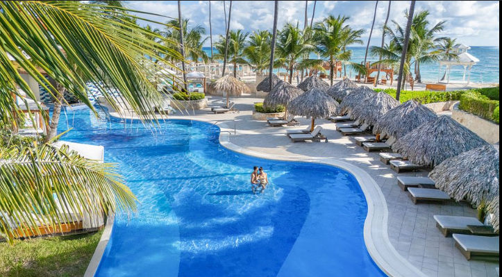 Aerial view of the beach, palapas, and resort facilities at Majestic Mirage Punta Cana