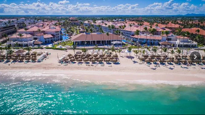 Aerial view of the beach, palapas, and resort facilities at Majestic Mirage Punta Cana.