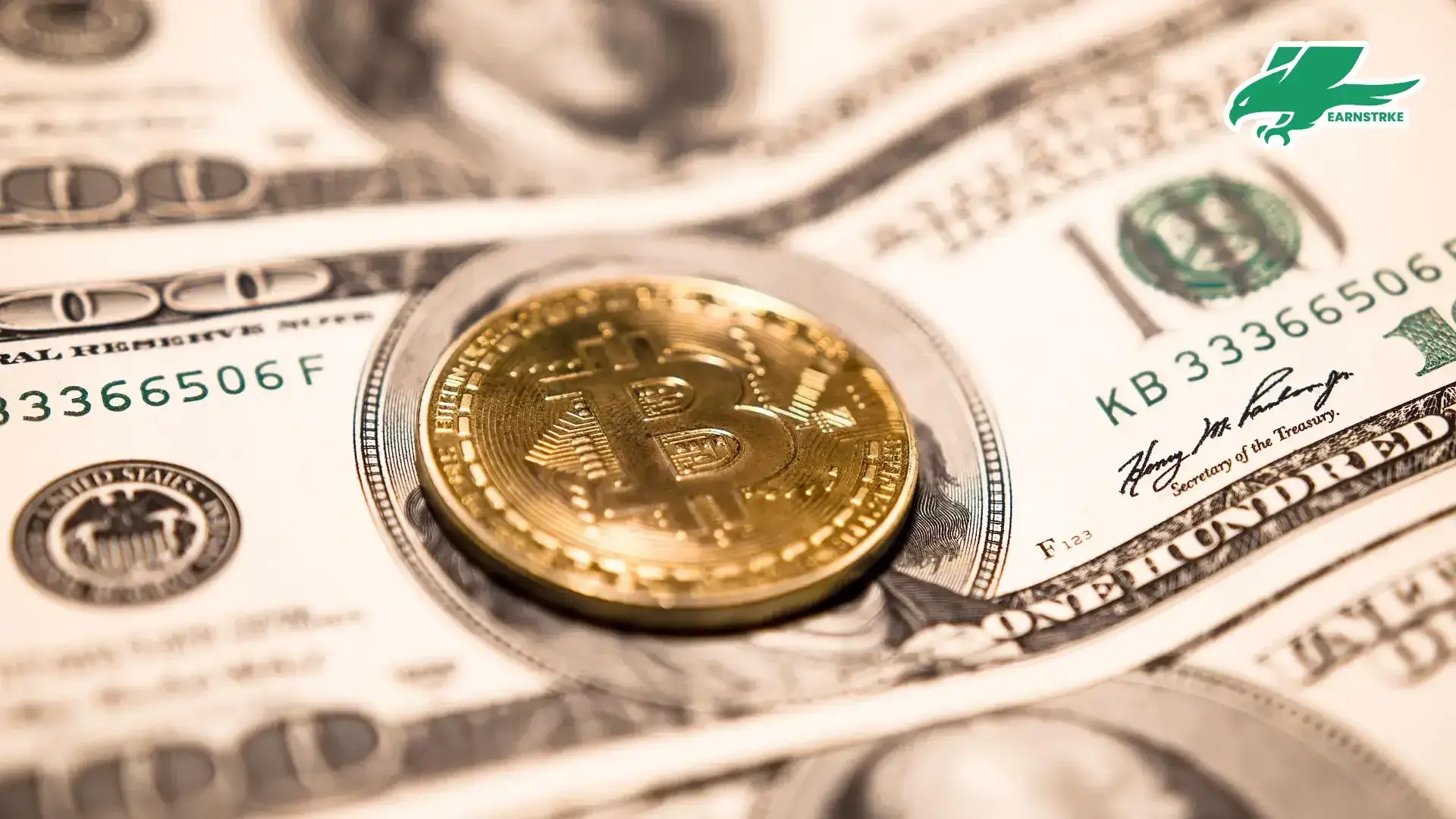 A bitcoin standing on top of the 100 dollars bill