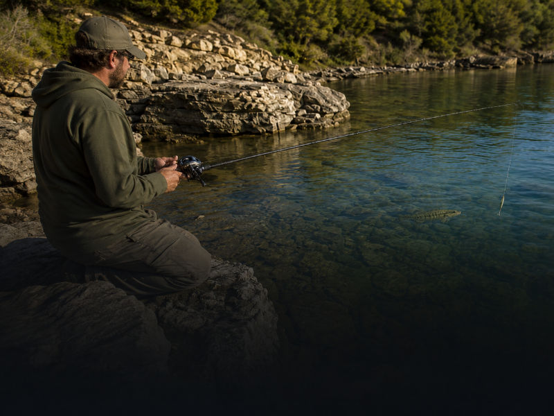 Bait finesse system fishing along a rocky lake shoreline