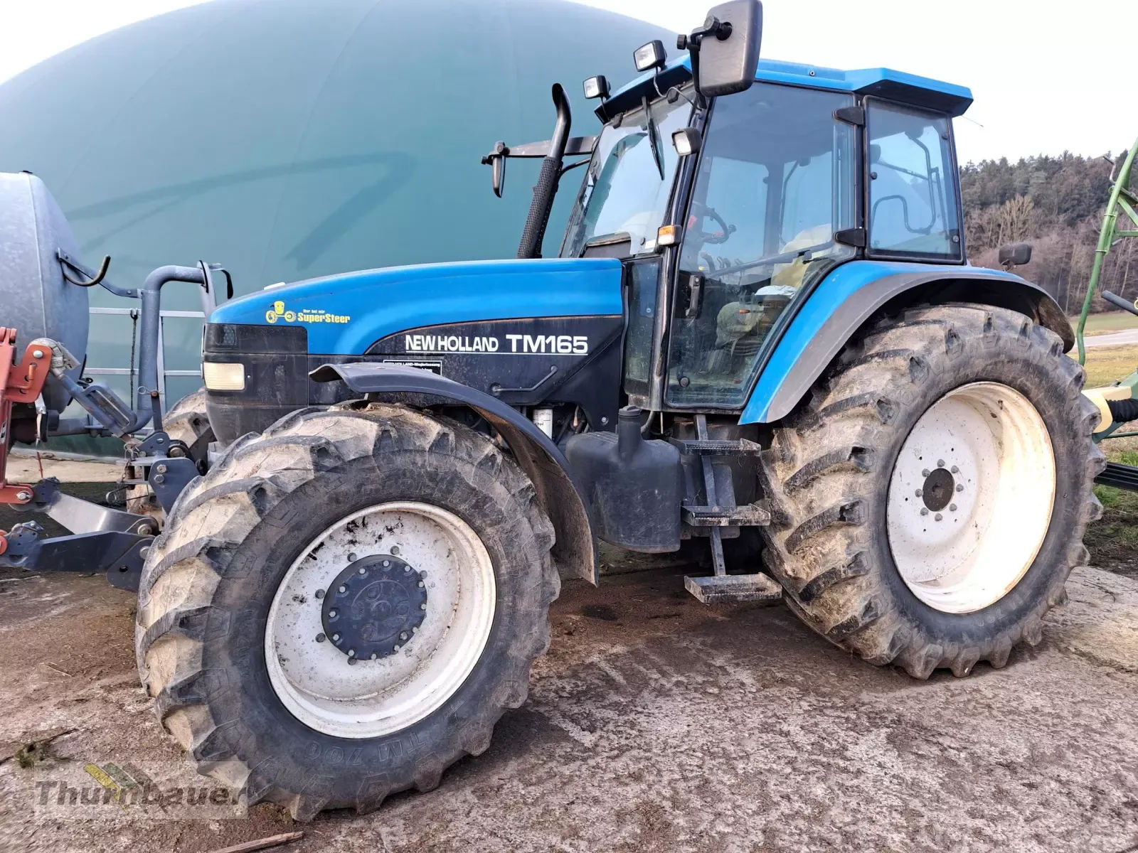 E-FARM: New Holland TM165 - Tractor - id EJH2EVK - 31.500 € - Año: 2000 - Horas: 4700,Potencia del motor: 165,Alemania