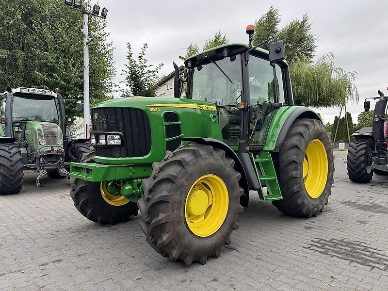 E-FARM: John Deere 6534 - Traktor - id AXJQRFC - 34.956 € - Baujahr: 2012 - Abgelesene Motorstunden: 8.200,Motorleistung (PS): 125,Polen