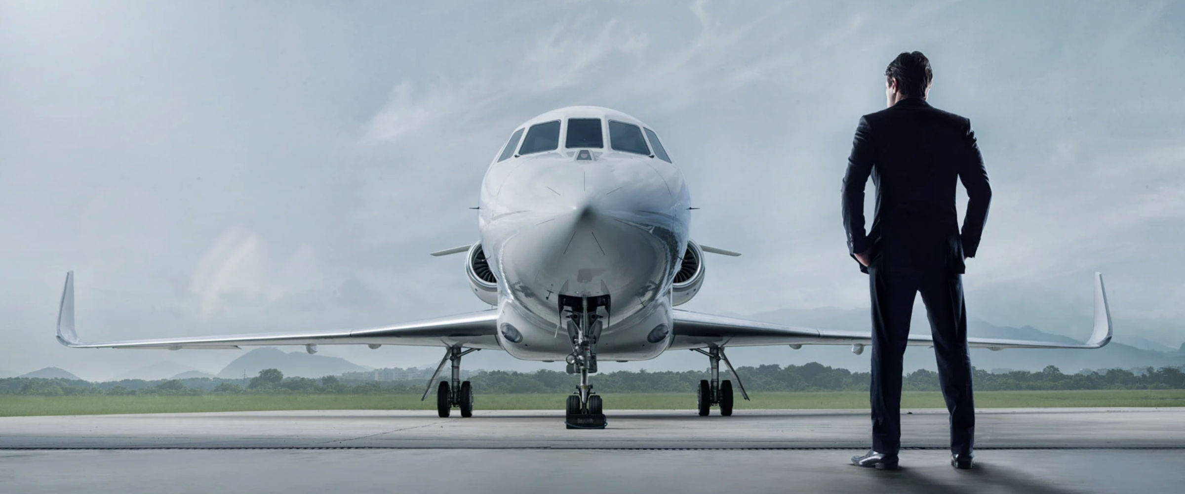 Chauffeured car meeting a private jet on the tarmac at dusk
