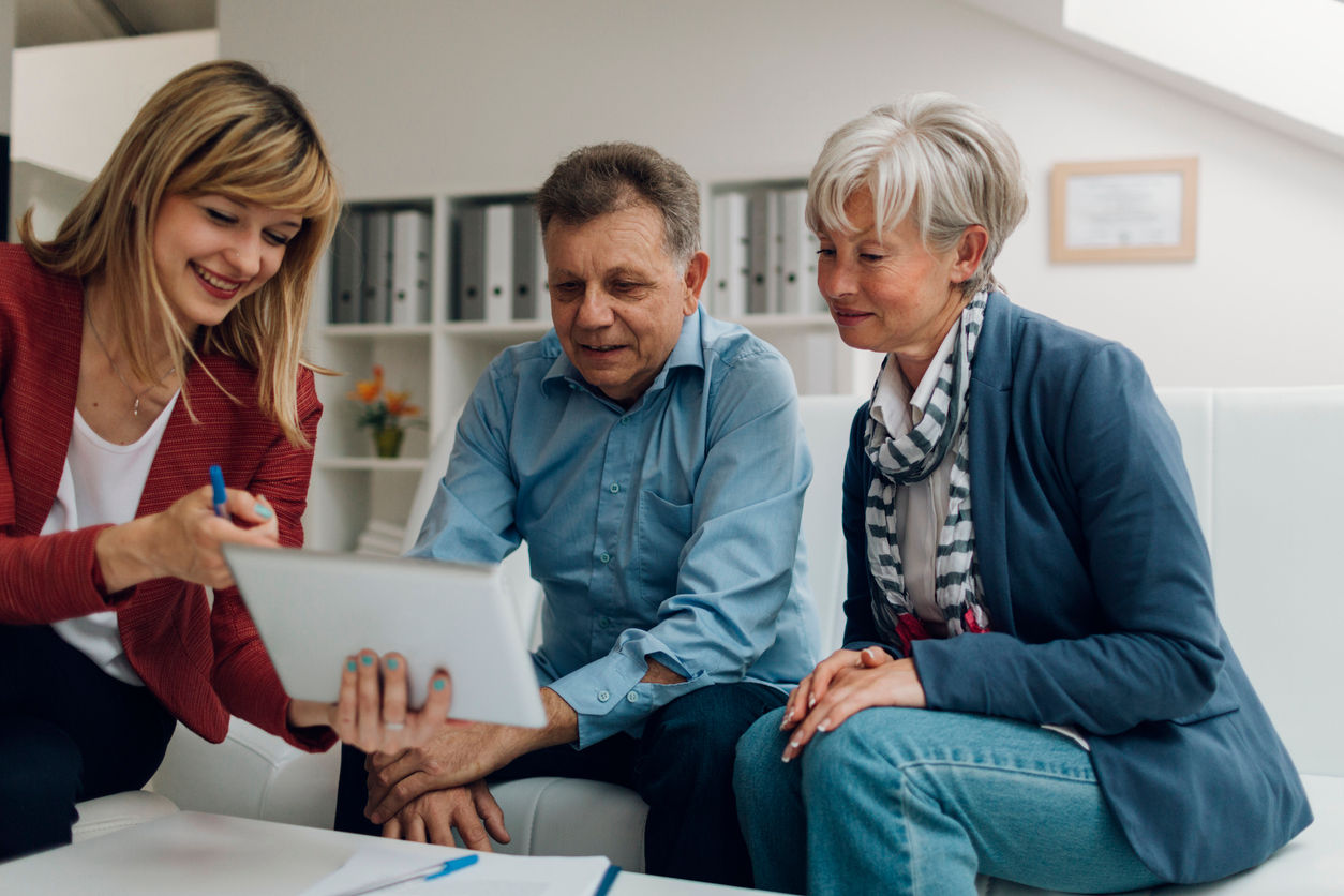 Financial advisor helping an older couple with estate planning via Guardian