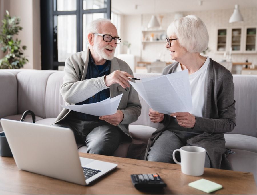 Wealthy older couple reviewing financial documents and estate taxes