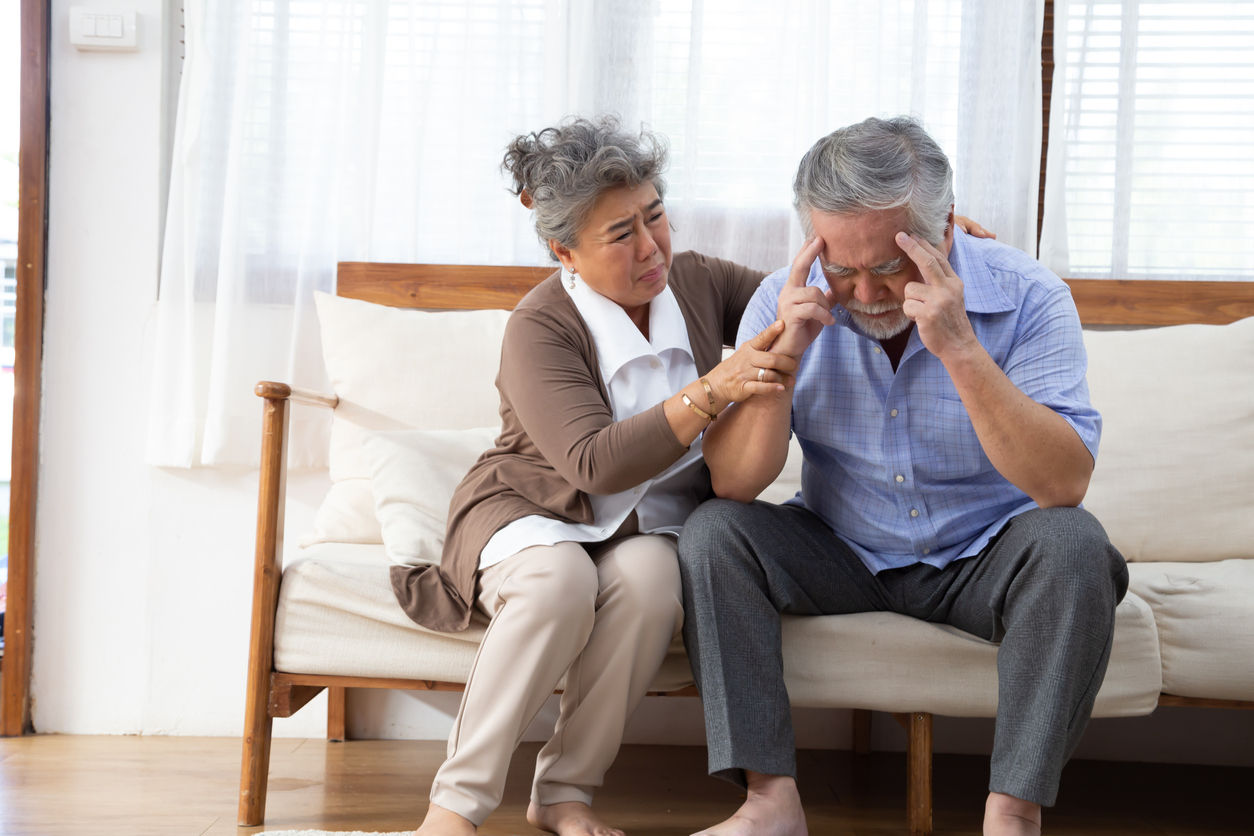 Woman sitting with man who has dementia