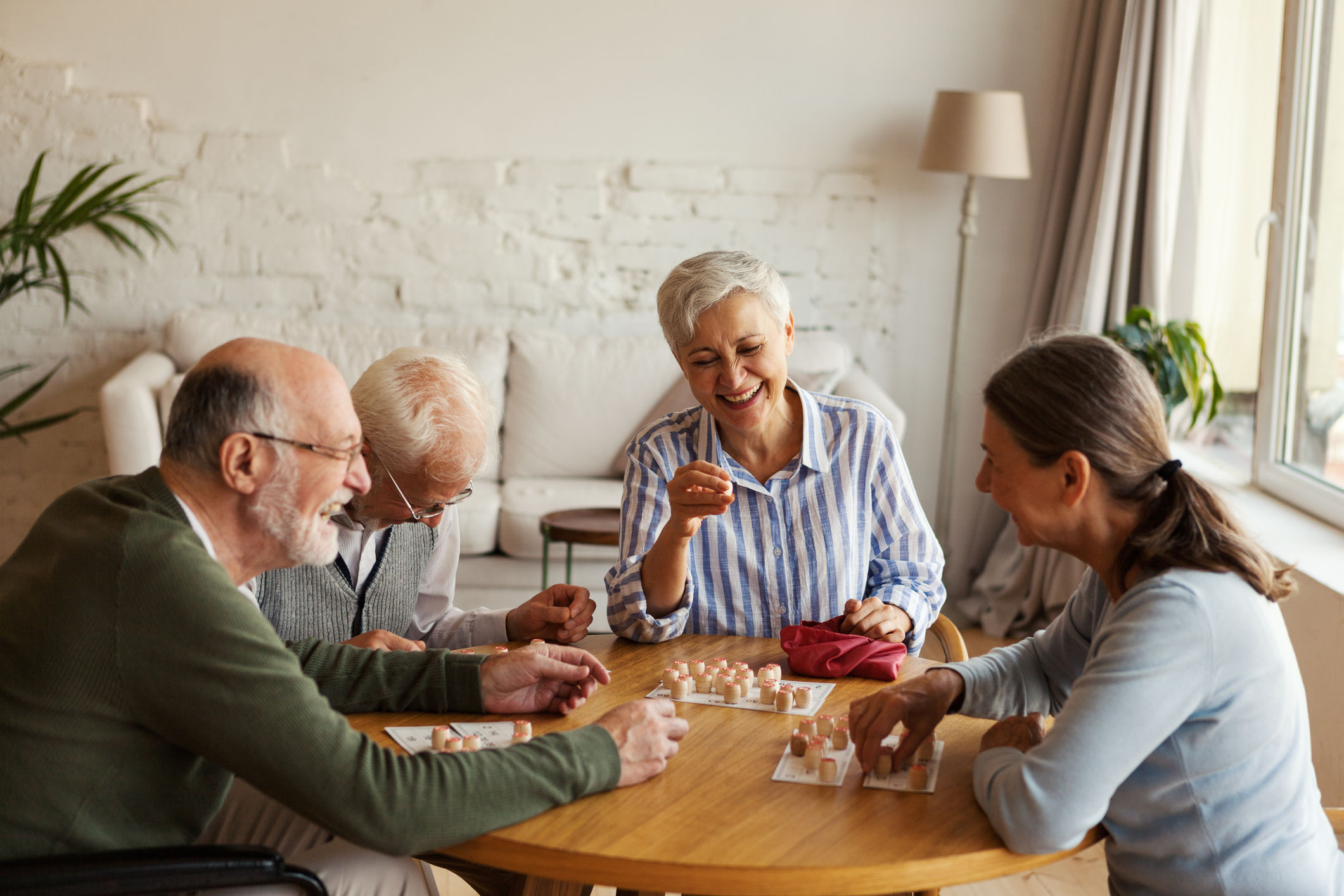 Group of friends welcoming a new short term stay member to a senior community