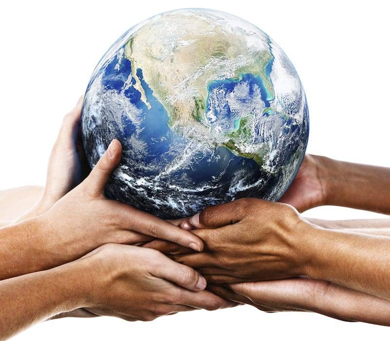 group of hands all holding up an earth globe