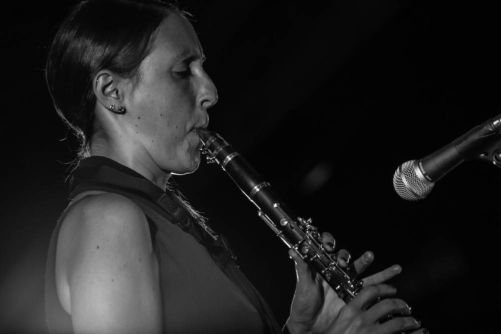 clarinet player on a stage with microphone