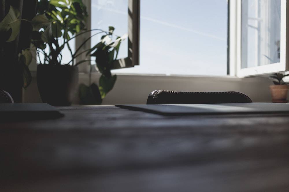 empty desk with a closed laptop