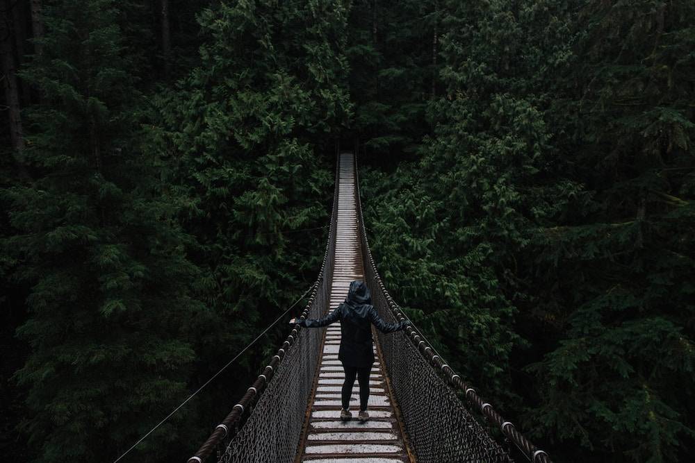 woman facing her fear crossing a bridge