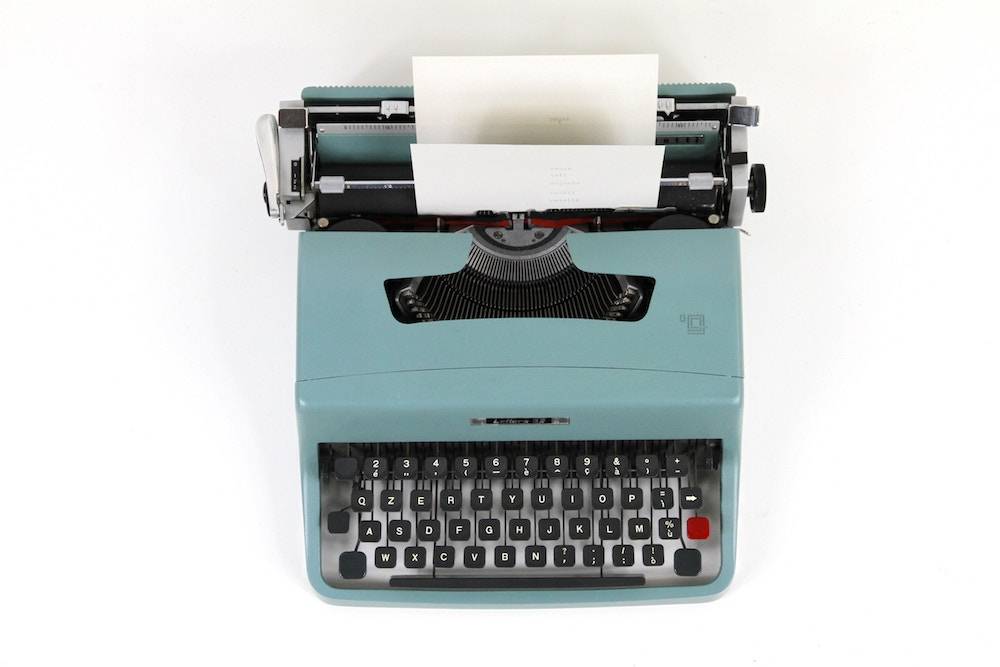 blue typewriter website copy writing tips