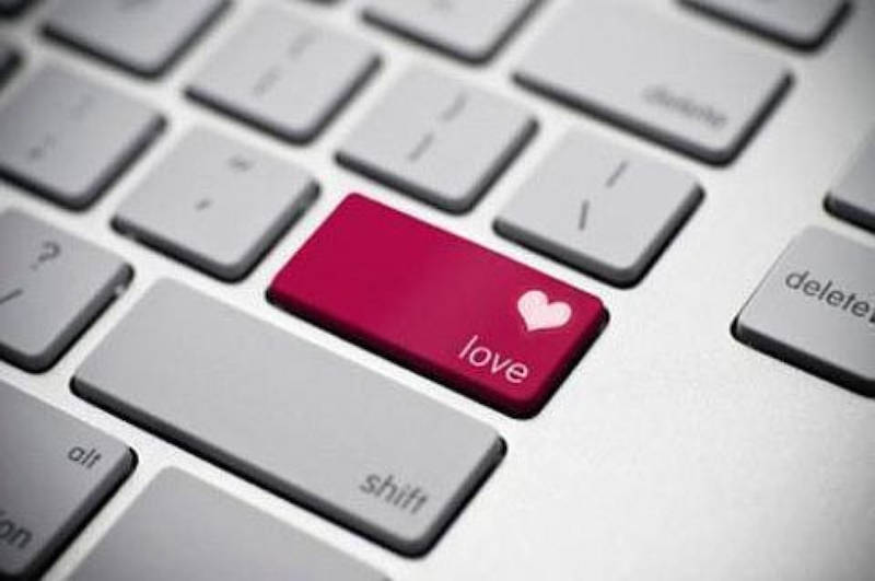 computer keyboard showing a pink "love" button with a heart on it