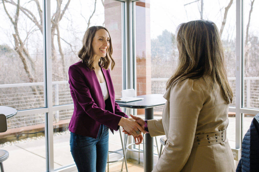 Janelle, owner of Ellanyze shaking hands with a new client