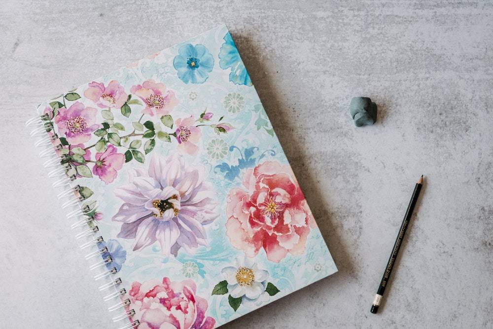 personal inventory a floral patterned notebook with pencil