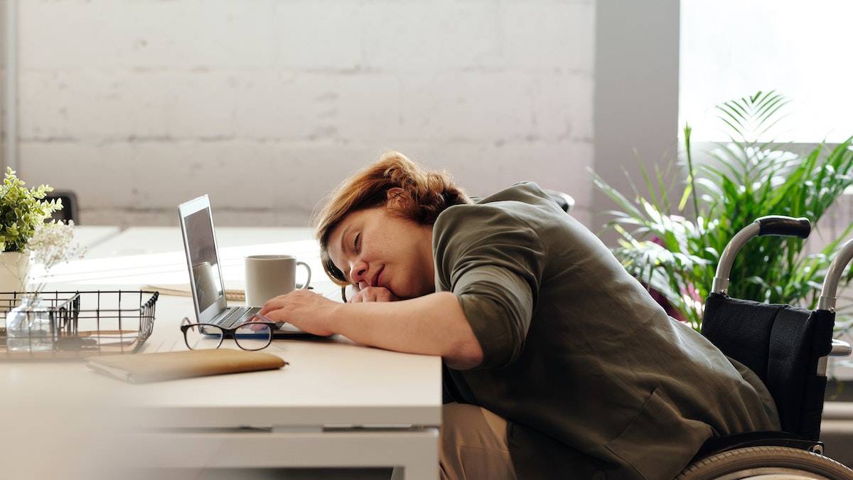 Zoom Fatigue a woman sleeping at her desk