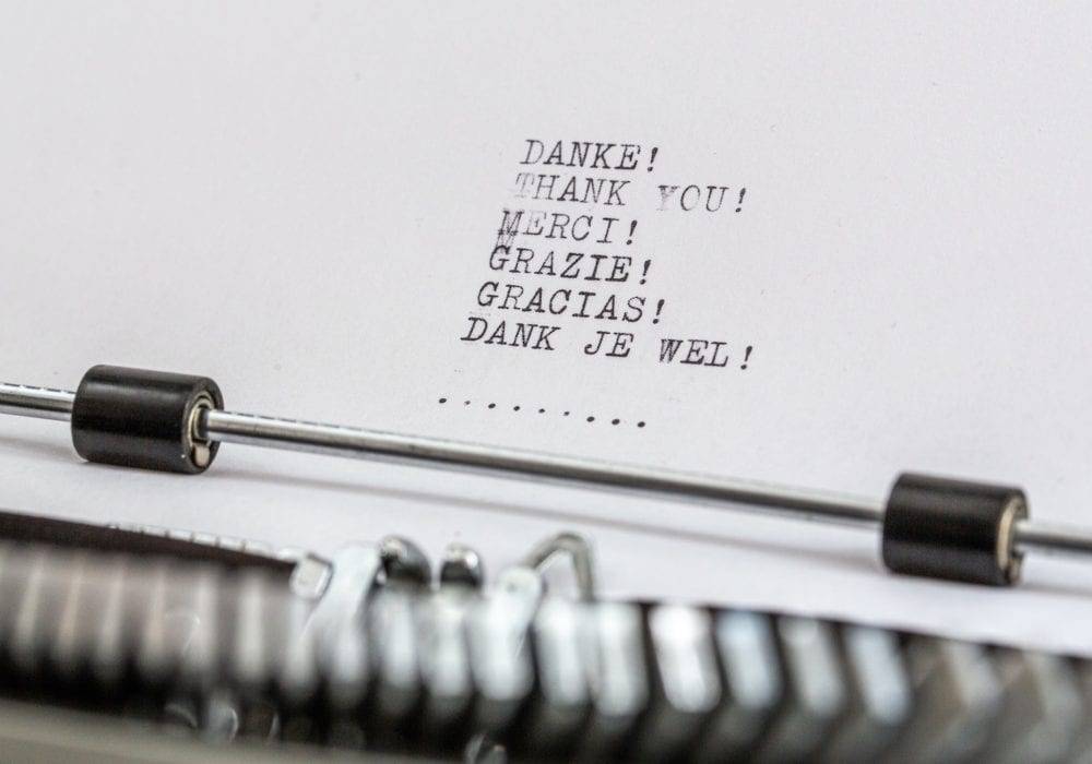 The Thank You List: a typewriter with the words for "thank you" on the page in six languages