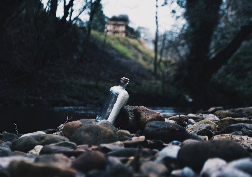 website content writing: a message in a bottle laying by the side of the river