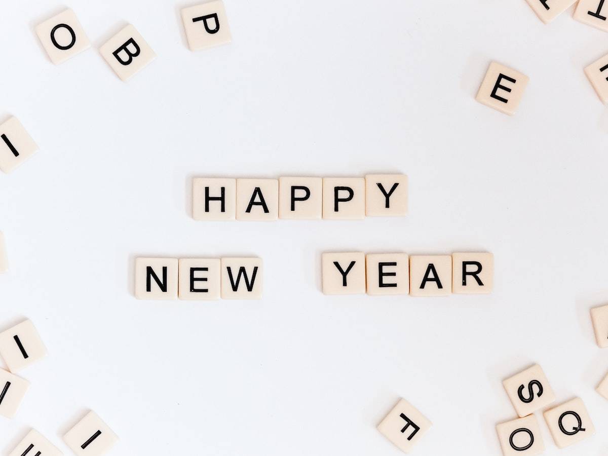 2021 Web Design Trends: scrabble letters on a top spelling out happy new year