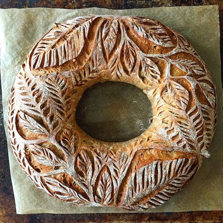 how to stay creative: a round loaf of bread with beautiful ornate carvings in the crust