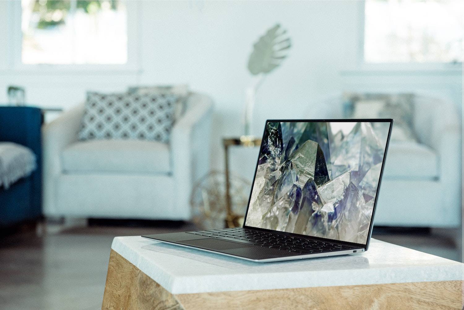 laptop with beautiful desktop image sitting on a coffee table