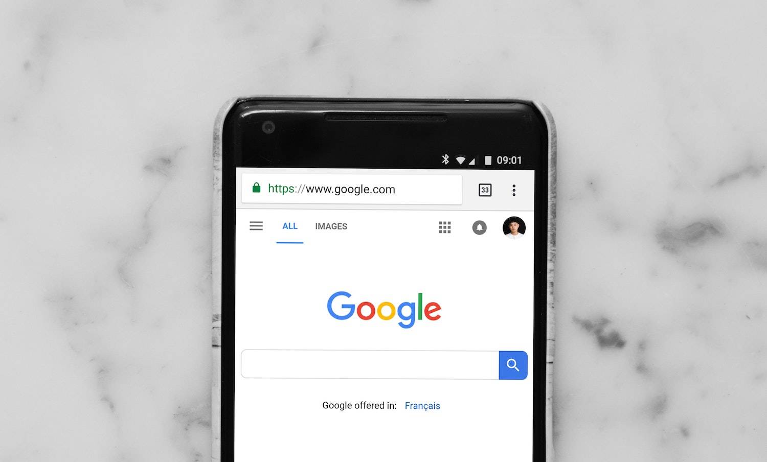 Best WordPress plugins for SEO and Better Page rank: Google front page on a cell phone sitting on top of a marble countertop