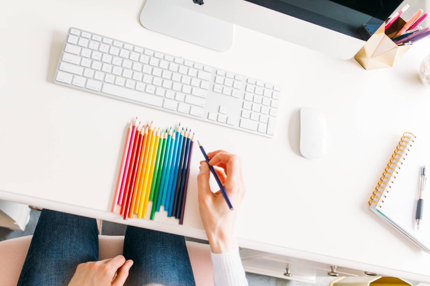 Janelle at her desk with colored pencils