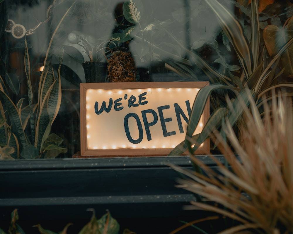 how to let it go - a store sign that says we're open