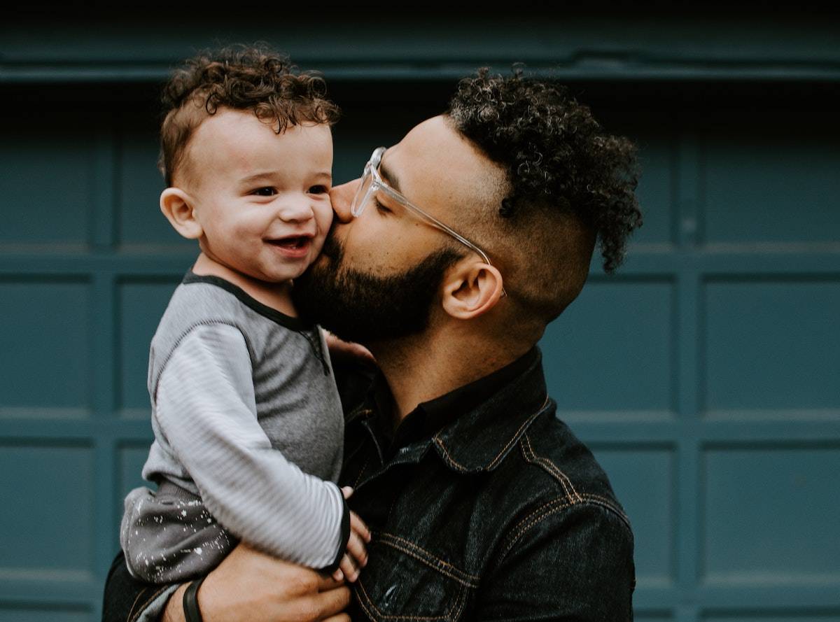 father and son kissing