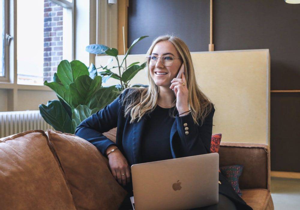 woman talking on the phone - successful first call with a prospective client