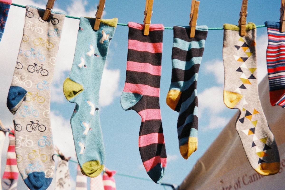 colorful and unique socks hanging on a clothesline