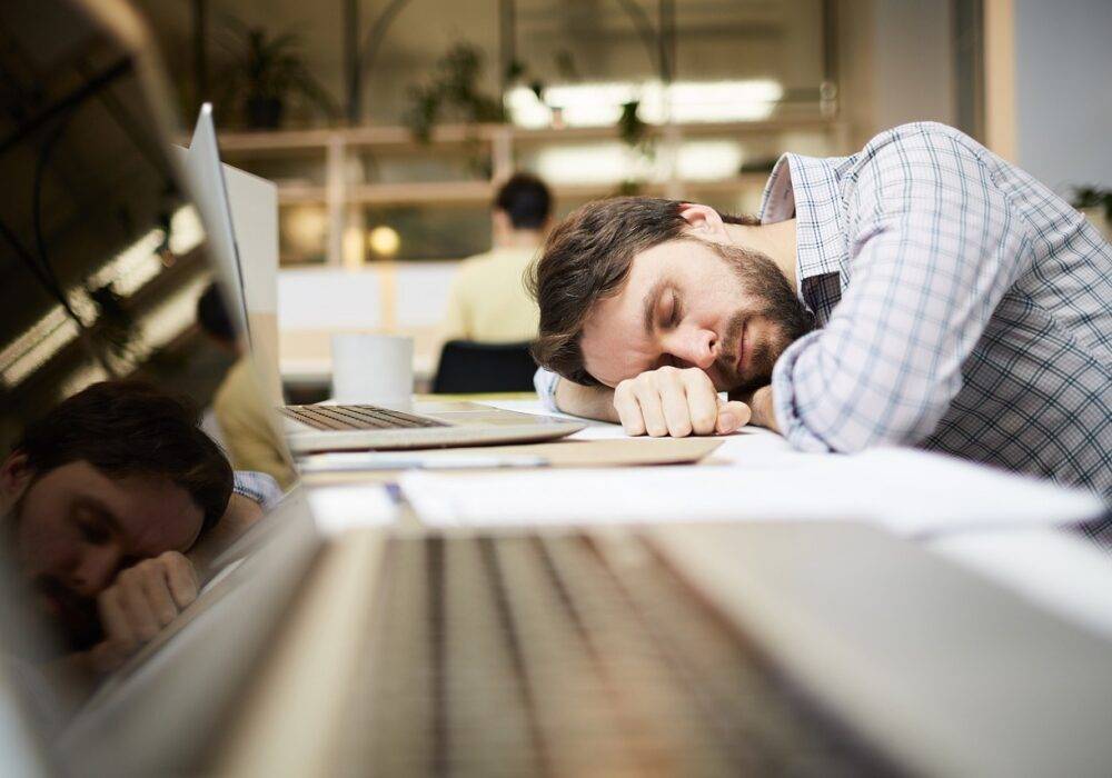 take care of yourself during busy times - man fell asleep at computer