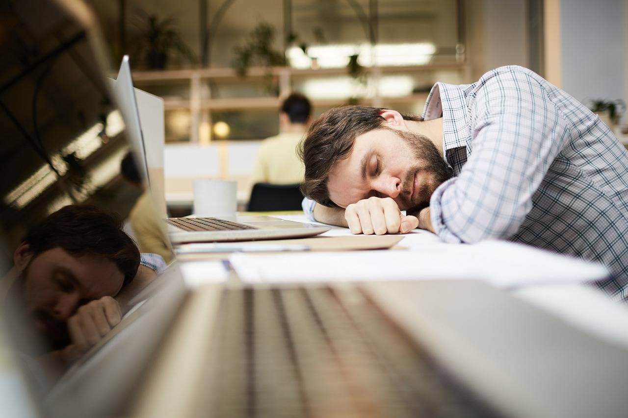 take care of yourself during busy times - man fell asleep at the computer